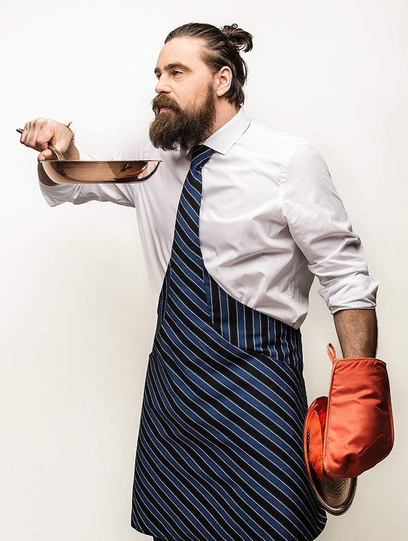 blue black white striped tie apron nice bearded man with cooking gloves and pan