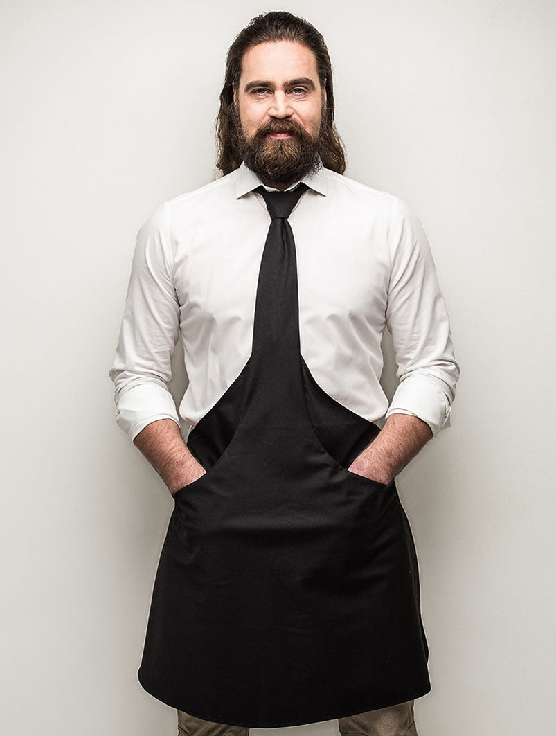 black tie apron bearded guy hands in pockets